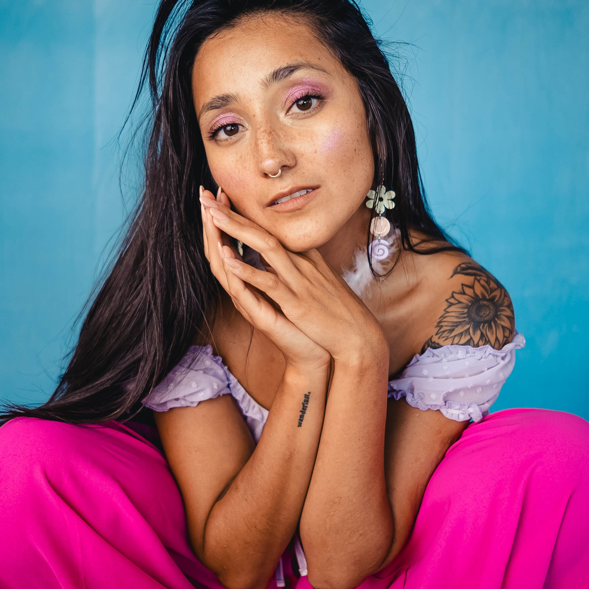 Beauty portrait with floral styling on teal